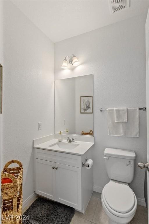 bathroom with tile patterned floors, vanity, and toilet