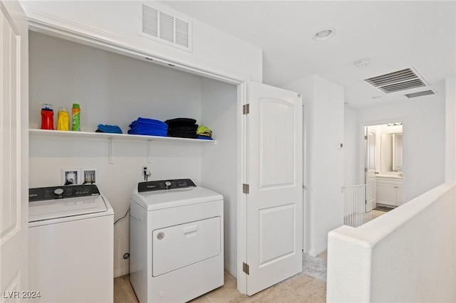 laundry area with independent washer and dryer