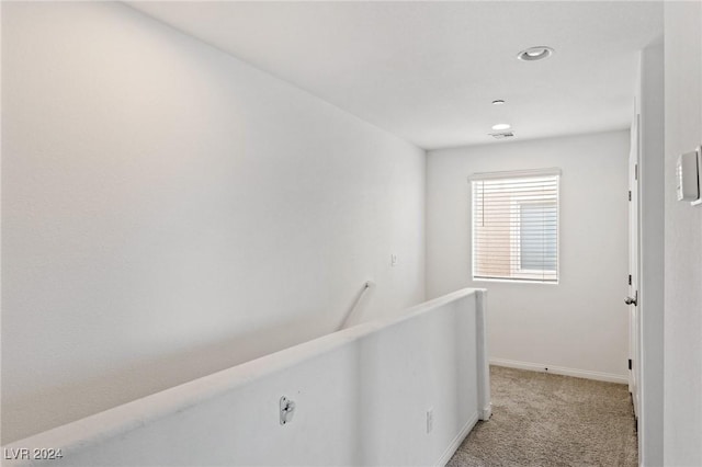 hallway with light colored carpet