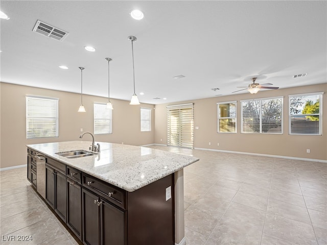 kitchen featuring ceiling fan, dark brown cabinets, plenty of natural light, and sink