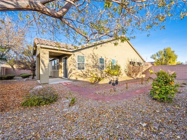 rear view of property featuring a patio area