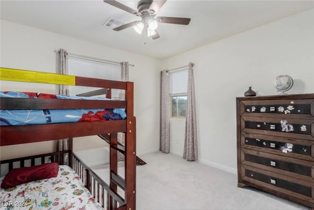 carpeted bedroom featuring visible vents, ceiling fan, and baseboards