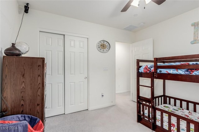 bedroom featuring carpet floors, a closet, baseboards, and a ceiling fan