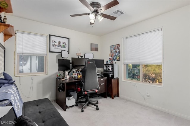 office with a ceiling fan, visible vents, light carpet, and baseboards