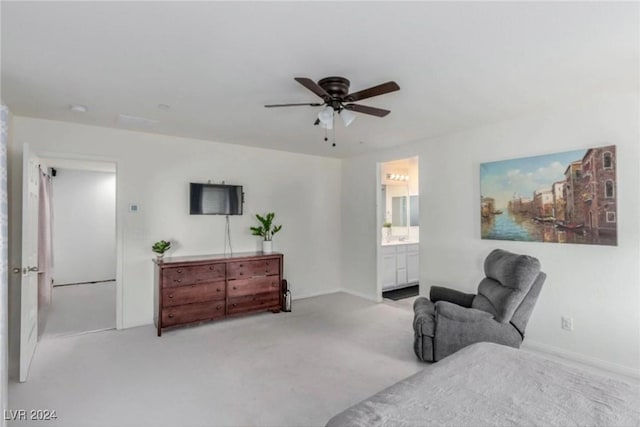 bedroom featuring carpet floors, a ceiling fan, and connected bathroom