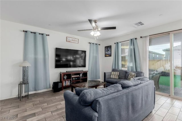 living area with ceiling fan, visible vents, and wood tiled floor