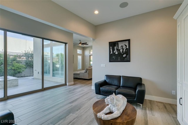 living room with ceiling fan and light wood-type flooring