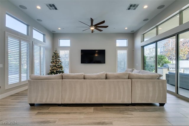 unfurnished living room with ceiling fan and light hardwood / wood-style floors