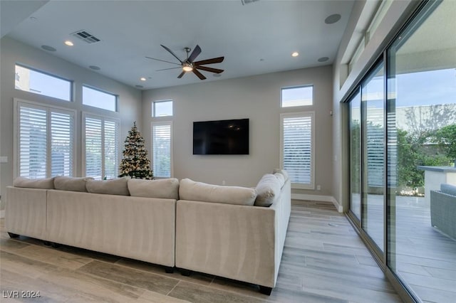 living room featuring ceiling fan and light hardwood / wood-style flooring