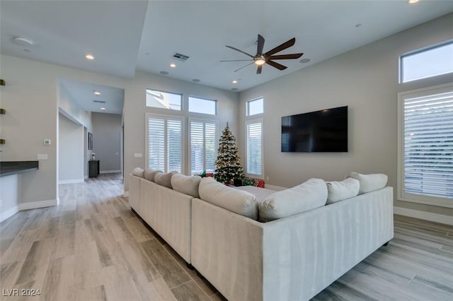 living room with ceiling fan and light hardwood / wood-style floors