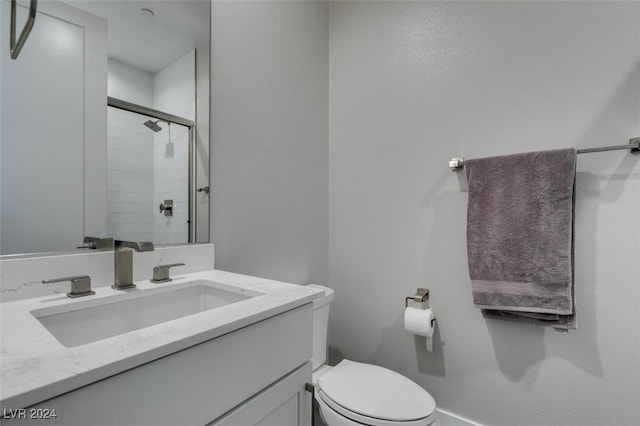 bathroom featuring vanity, toilet, and walk in shower