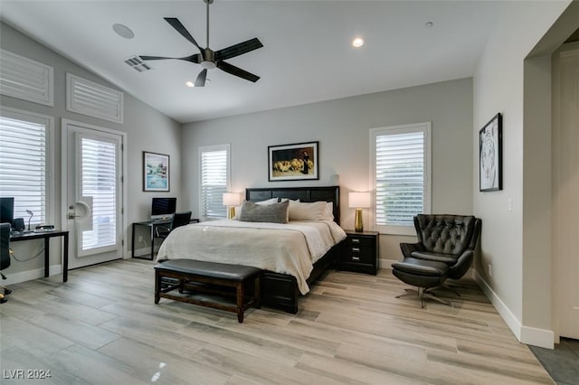 bedroom featuring light hardwood / wood-style floors, ceiling fan, and lofted ceiling