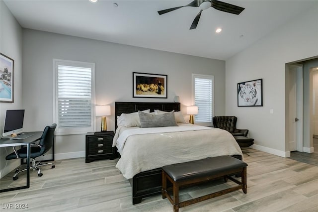 bedroom featuring ceiling fan, light hardwood / wood-style floors, and lofted ceiling