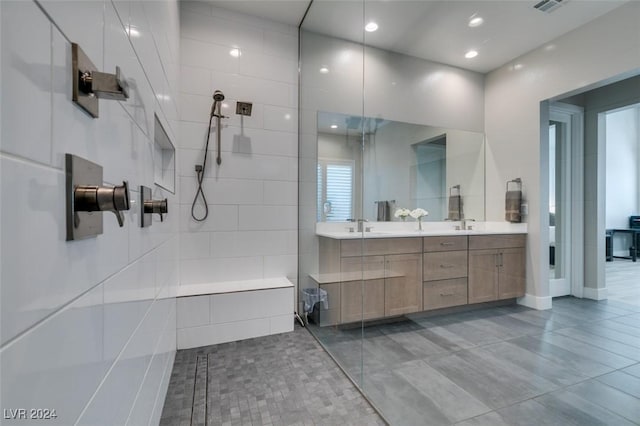 bathroom featuring tile patterned floors, a shower, and vanity