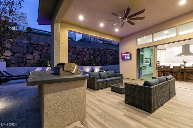 view of patio with ceiling fan, a grill, an outdoor living space, and an outdoor bar