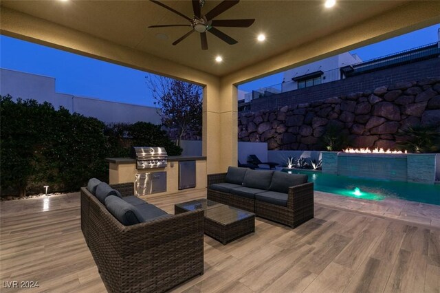 wooden terrace with outdoor lounge area, ceiling fan, grilling area, pool water feature, and area for grilling