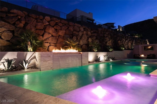 view of swimming pool featuring a fireplace