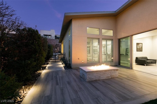 deck at dusk with an outdoor fire pit