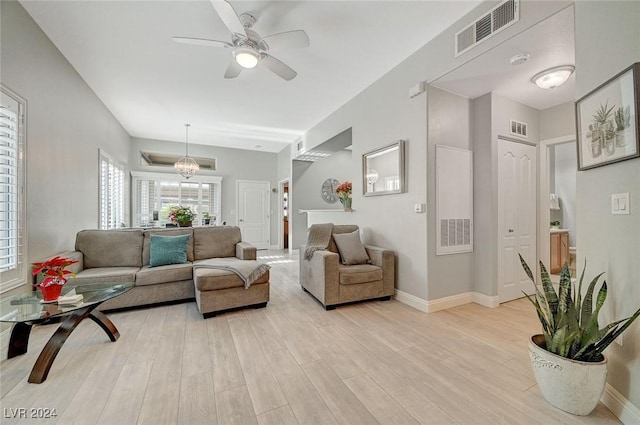 living room with ceiling fan and light hardwood / wood-style floors