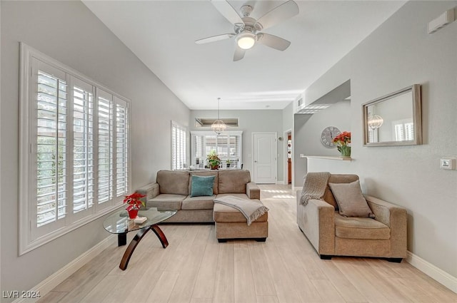 living room with light wood-type flooring and ceiling fan