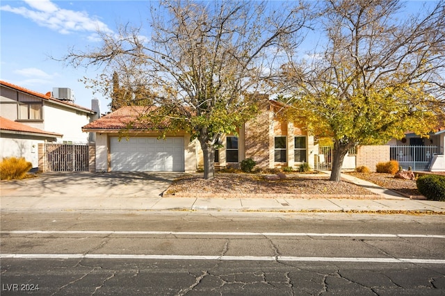 view of front facade with central AC unit and a garage