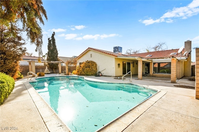 view of swimming pool with central AC unit and a patio