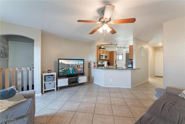 tiled living room featuring ceiling fan