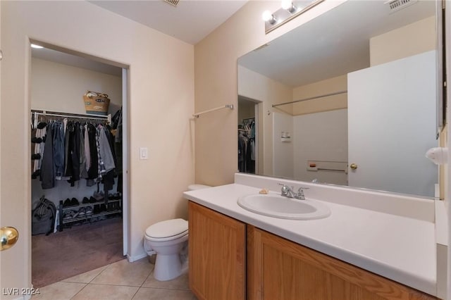 bathroom featuring tile patterned flooring, vanity, and toilet