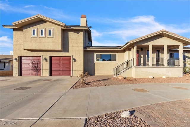 view of front of property featuring a garage and covered porch