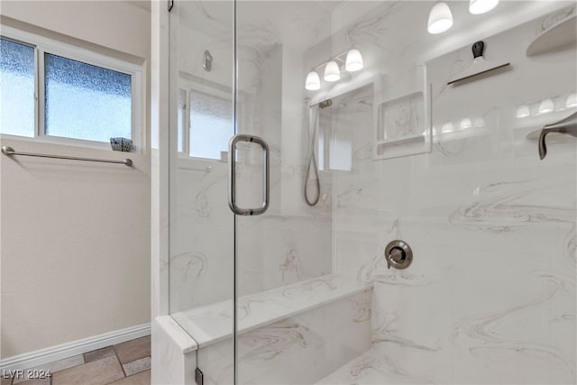 bathroom with a shower with door