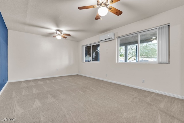 unfurnished room with ceiling fan, light carpet, and a wall unit AC