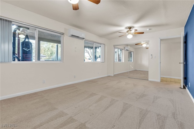 unfurnished room featuring ceiling fan, light carpet, and a wall unit AC