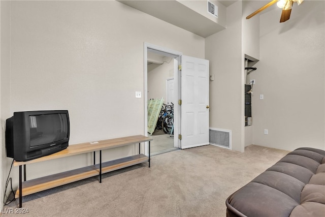 living room featuring light colored carpet and ceiling fan