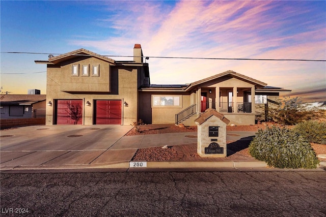 view of front of home featuring a garage and solar panels