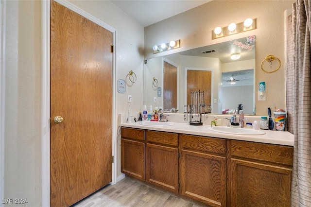 bathroom featuring hardwood / wood-style floors, vanity, and ceiling fan