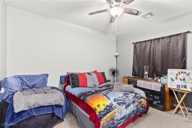 carpeted bedroom featuring a ceiling fan and visible vents