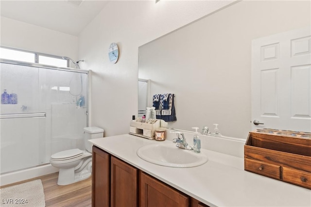 bathroom featuring lofted ceiling, toilet, a shower stall, and vanity