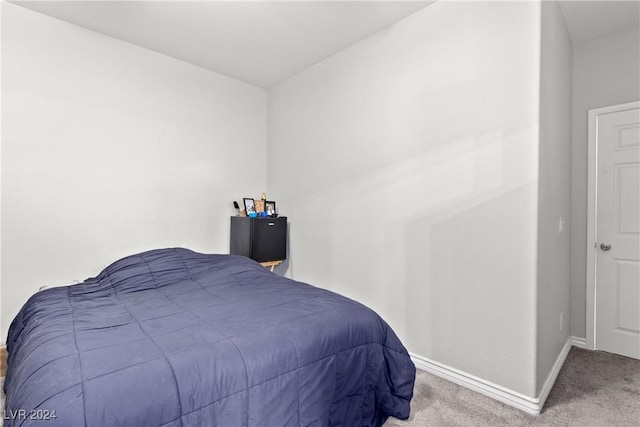 carpeted bedroom featuring baseboards