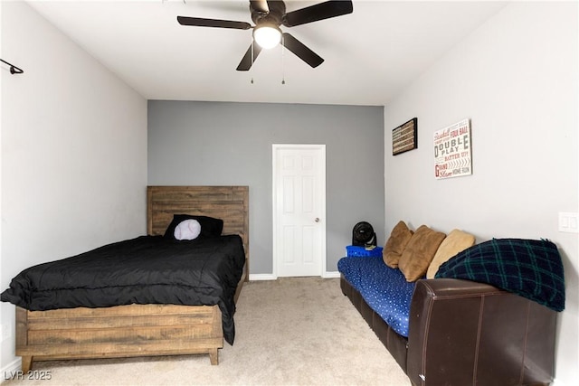 carpeted bedroom with a ceiling fan and baseboards