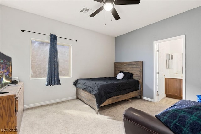 bedroom with light carpet, connected bathroom, visible vents, and baseboards