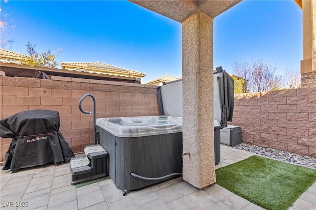 view of patio / terrace featuring a fenced backyard, a grill, a hot tub, and central AC unit