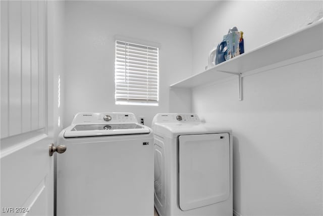 clothes washing area featuring separate washer and dryer