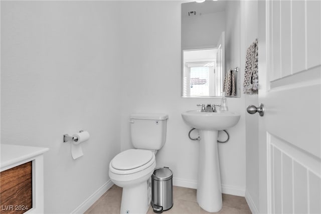 bathroom featuring tile patterned flooring, toilet, and sink