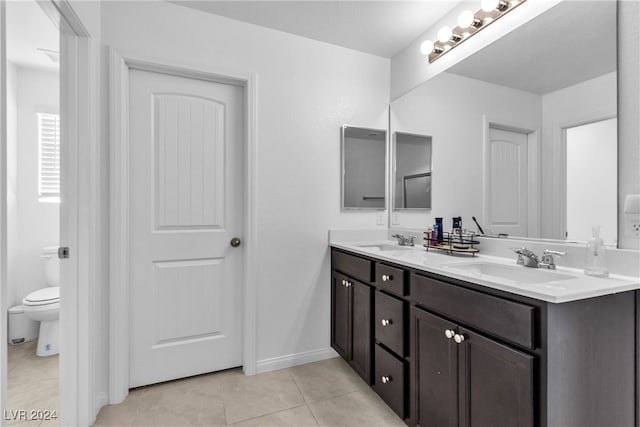 bathroom featuring tile patterned flooring, vanity, and toilet