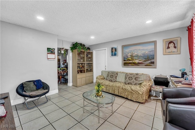 living room featuring light tile patterned floors and a textured ceiling