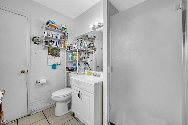 bathroom with tile patterned flooring, vanity, and toilet