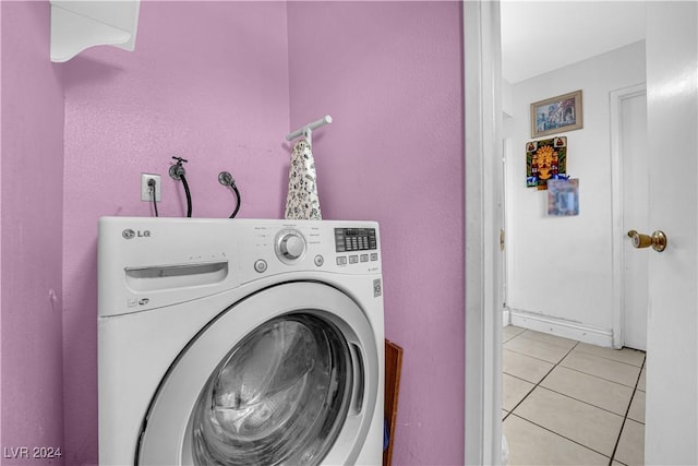 washroom with washer / dryer and light tile patterned flooring