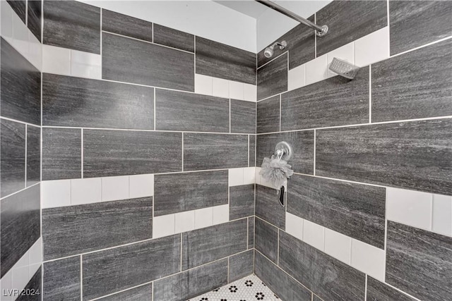 interior details featuring a tile shower