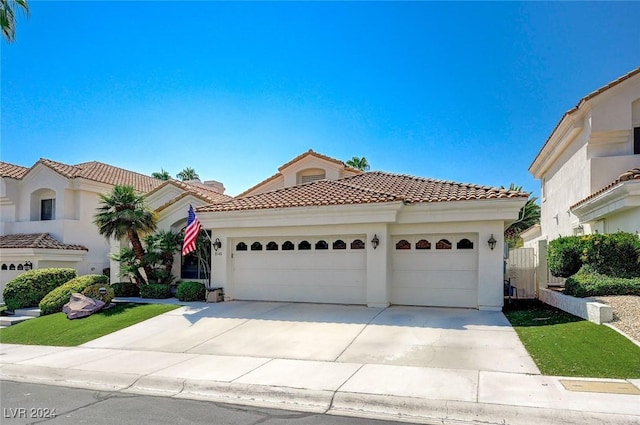 mediterranean / spanish house with a garage