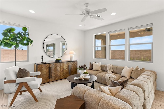 living room featuring a wealth of natural light and light hardwood / wood-style flooring